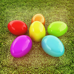 Image showing Colored Easter eggs as a flower on a green grass. 3D illustratio