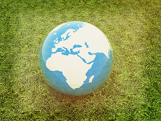 Image showing earth on a green grass. 3D illustration. Vintage style.