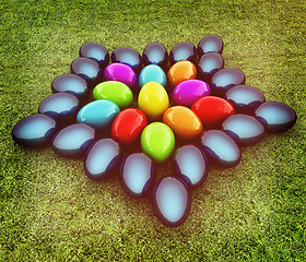 Image showing Colored Easter eggs as a flower on a green grass. 3D illustratio