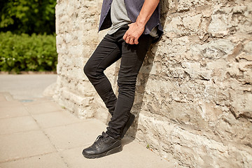 Image showing close up of man standing at street wall