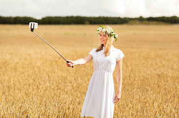 Image showing happy young woman taking selfie by smartphone