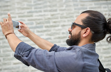 Image showing hipster man taking picture on smartphone