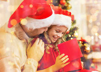 Image showing smiling father and daughter opening gift box