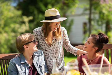 Image showing happy friends having dinner at summer garden party