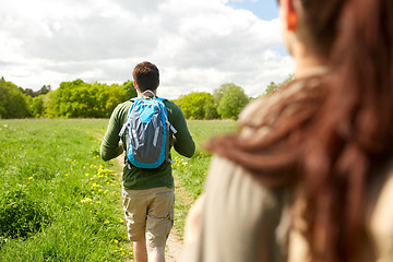 Image showing close up of couple with backpacks hiking outdoors