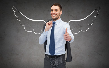 Image showing businessman with angel wings showing thumbs up