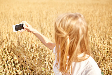 Image showing close up of girl with smartphone on cereal field