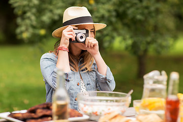 Image showing close up of woman with camera shooting outdoors