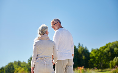 Image showing happy senior couple walking outdoors