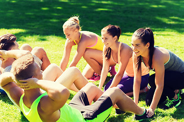 Image showing group of friends or sportsmen exercising outdoors