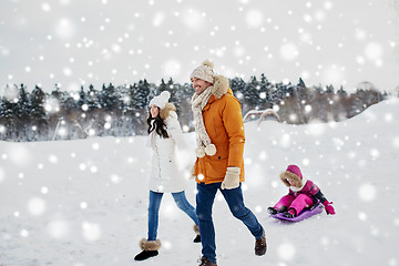 Image showing happy family with sled walking in winter outdoors