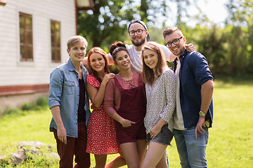 Image showing happy teenage friends hugging at summer garden