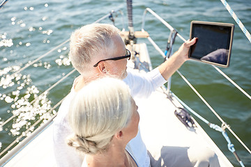 Image showing senior couple with tablet pc on sail boat or yacht