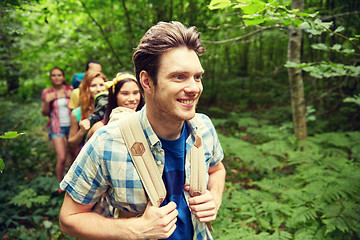 Image showing group of smiling friends with backpacks hiking