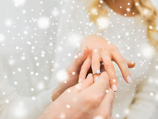 Image showing close up of man giving diamond ring to woman