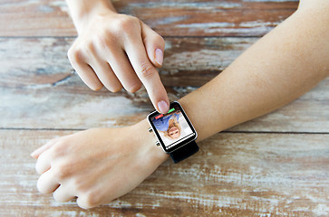 Image showing close up of hands with incoming call on smartwatch