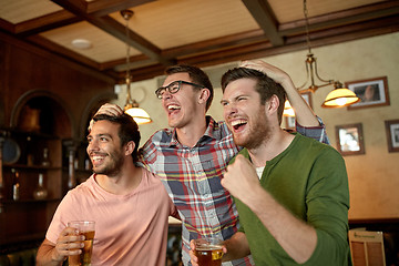 Image showing friends with beer watching sport at bar or pub