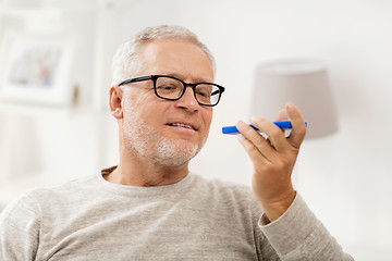 Image showing old man using voice command recorder on smartphone