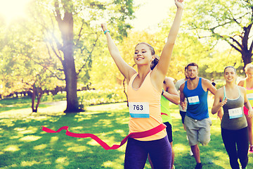 Image showing happy young female runner winning on race finish