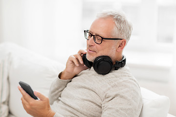 Image showing happy senior man with smartphone and headphones