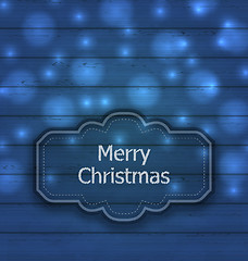 Image showing Christmas label on wooden texture with light