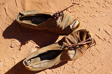 Image showing old pair of shoes on sand