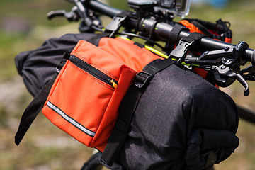 Image showing Bicycle with orange bags for travel