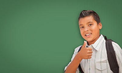 Image showing Cute Hispanic Boy In Front of Blank Chalk Board