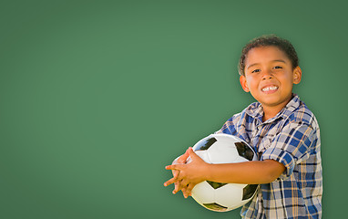 Image showing Cute Young Mixed Race Boy Holding Soccer Ball In Front of Blank 