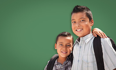 Image showing Cute Hispanic Boys In Front of Blank Chalk Board