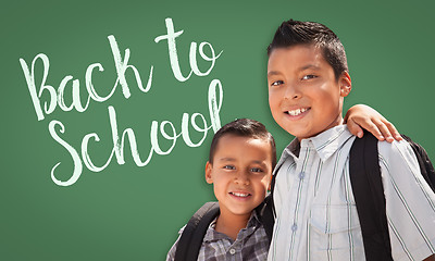 Image showing Hispanic Boys Wearing Backpacks In Front of Back To School Writt