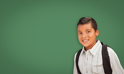 Image showing Cute Hispanic Boy In Front of Blank Chalk Board