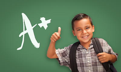 Image showing Hispanic Boy with Thumbs Up in Front of A+ Written on Chalk Boar