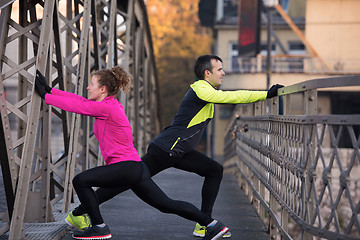 Image showing couple warming up before jogging
