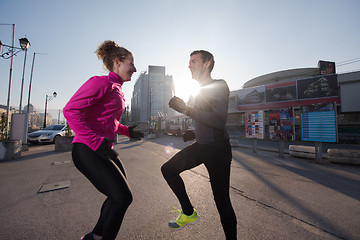 Image showing couple warming up before jogging