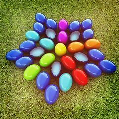 Image showing Colored Easter eggs as a flower on a green grass. 3D illustratio