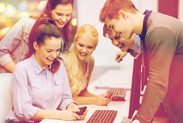 Image showing students with computer monitor and smartphones