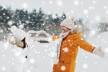 Image showing happy couple playing with snow in winter