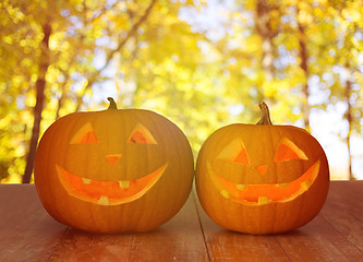 Image showing close up of pumpkins on wooden table outdoors