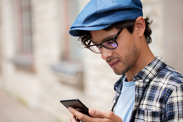 Image showing close up of man texting message on smartphone