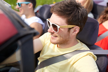 Image showing happy friends driving in cabriolet car