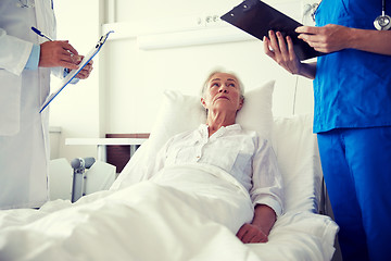 Image showing doctor and nurse visiting senior woman at hospital