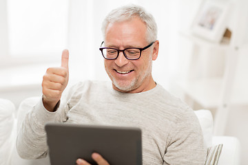 Image showing senior man having video call on tablet pc at home