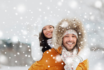 Image showing happy couple having fun over winter background