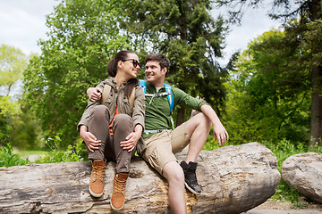 Image showing smiling couple with backpacks in nature