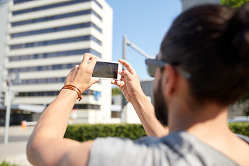 Image showing hipster man taking picture on smartphone