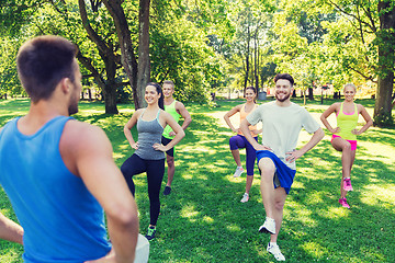 Image showing group of friends or sportsmen exercising outdoors