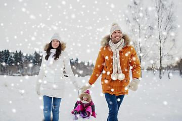 Image showing happy family with sled walking in winter outdoors