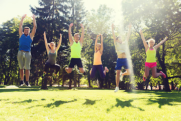 Image showing group of happy friends jumping high outdoors