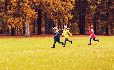 Image showing group of happy little kids running outdoors